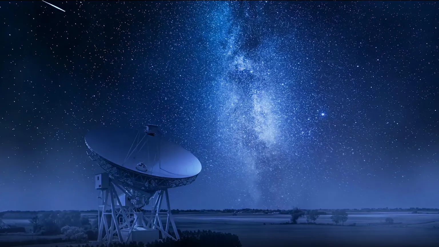 Radio telescope dish pointing toward starry night sky with visible Milky Way galaxy, representing network monitoring and threat detection technology