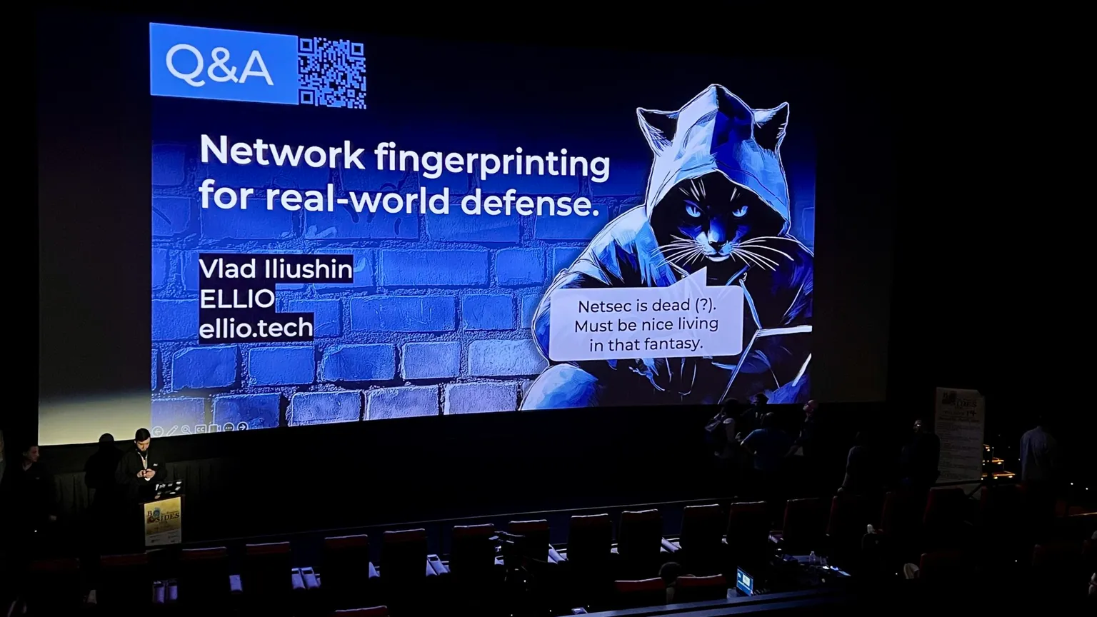 Conference presentation slide showing "Network fingerprinting for real-world defense" by Vlad Iliushin from ELLIO, featuring a hooded cat mascot of ELLIO, at BSides San Francisco.
