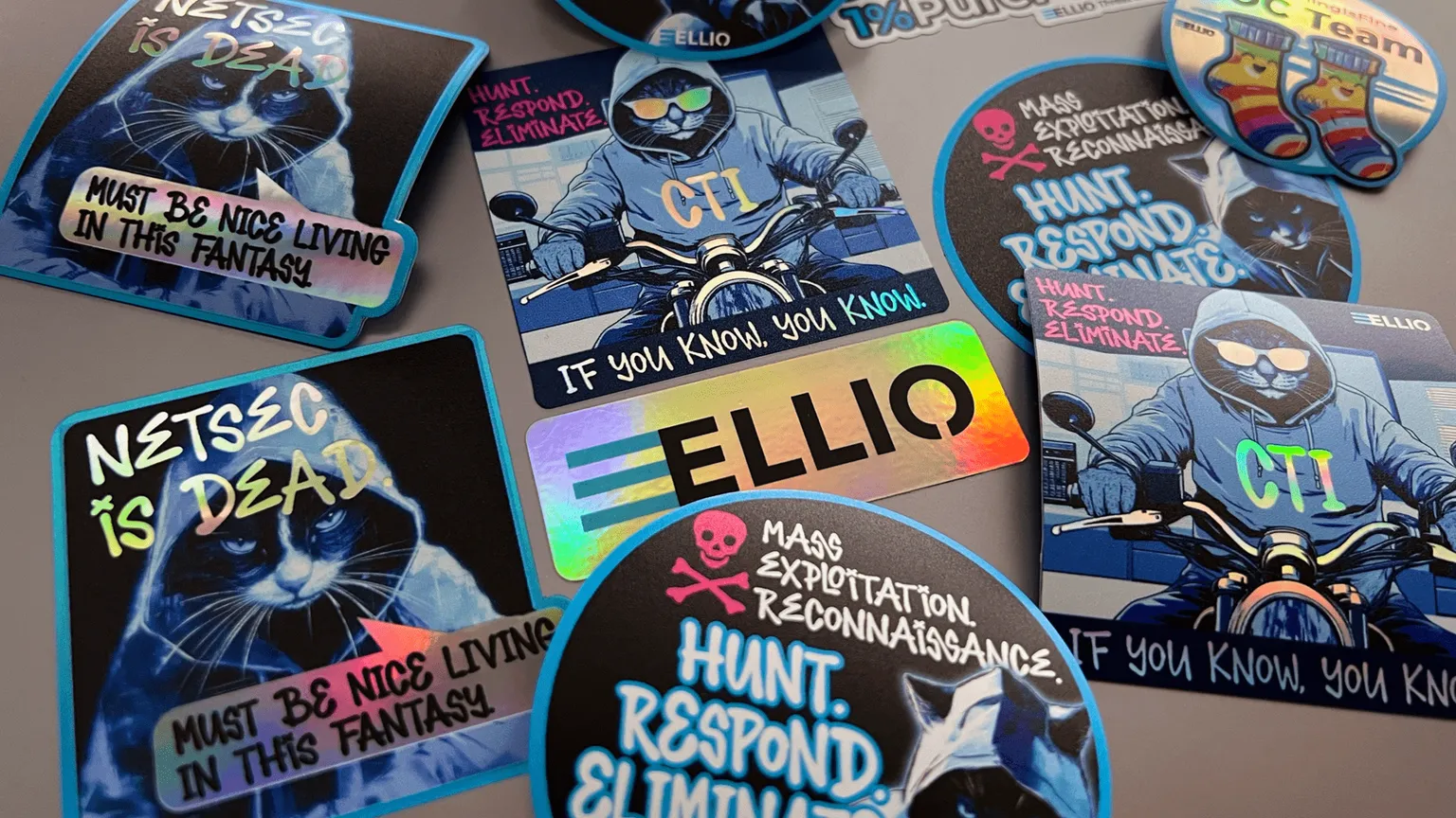 ELLIO cybersecurity stickers with ELLIO's hacker cat masquot Jack at BSides Prague.